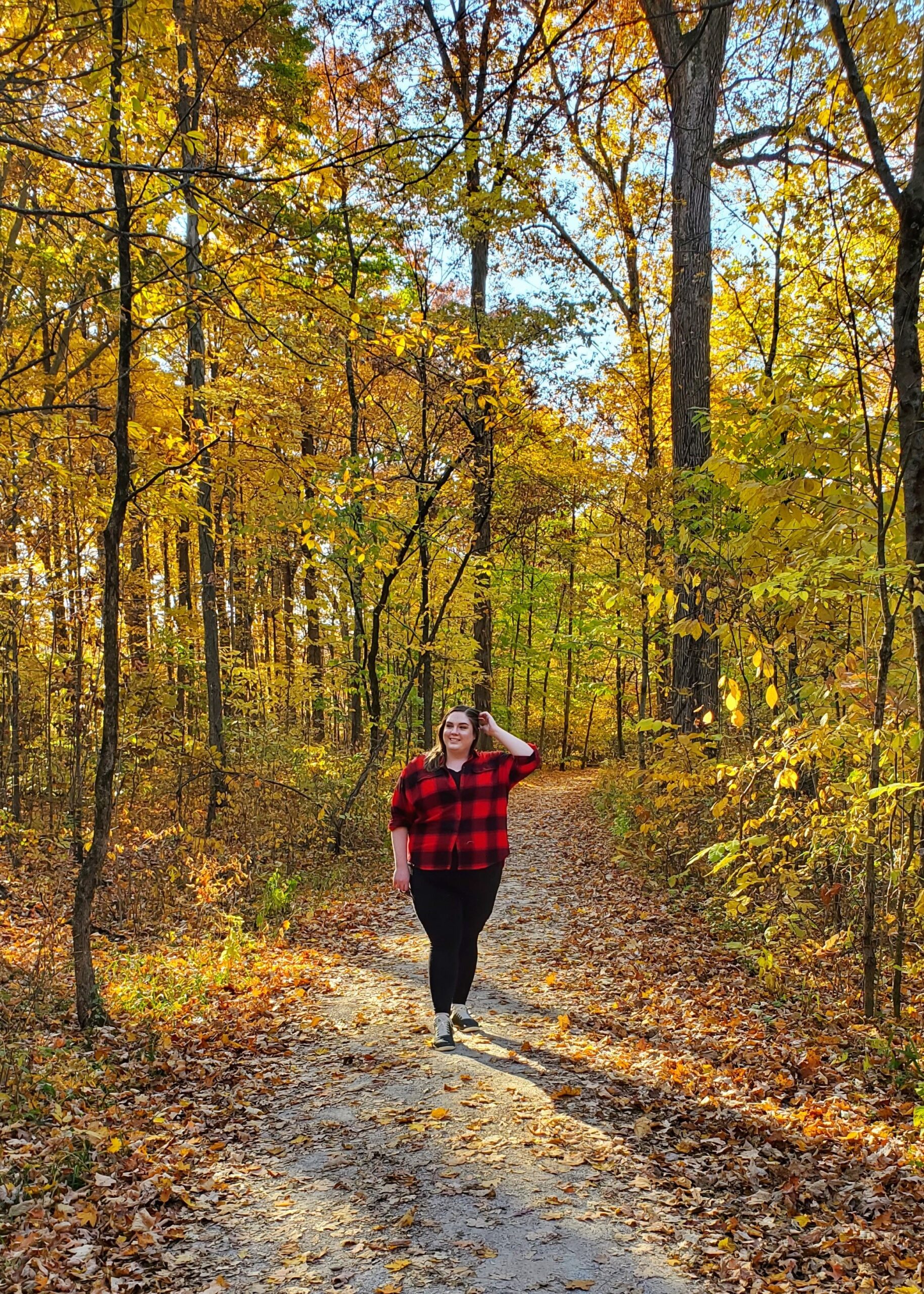 the author in a fat body enjoying a fall hike